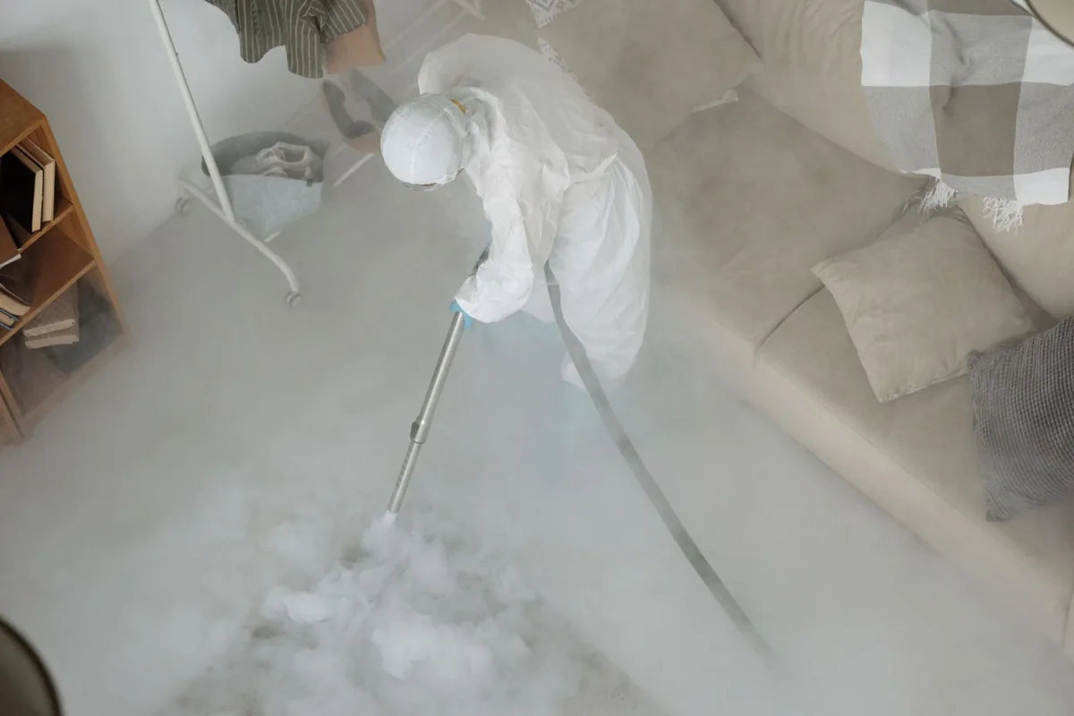 Biohazard cleanup technician in protective equipment, Waldo, AR